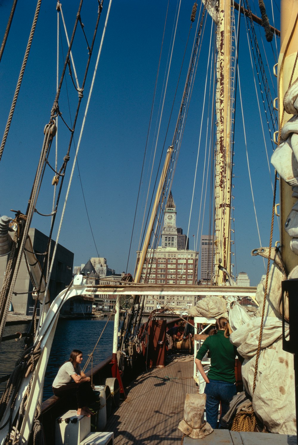 a group of people standing on the deck of a boat