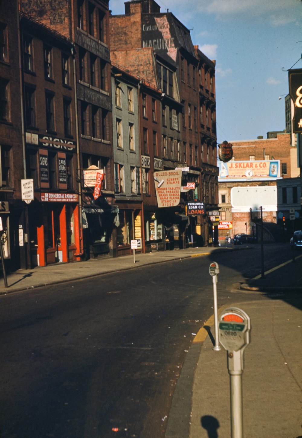 a street with a parking meter on the side of it