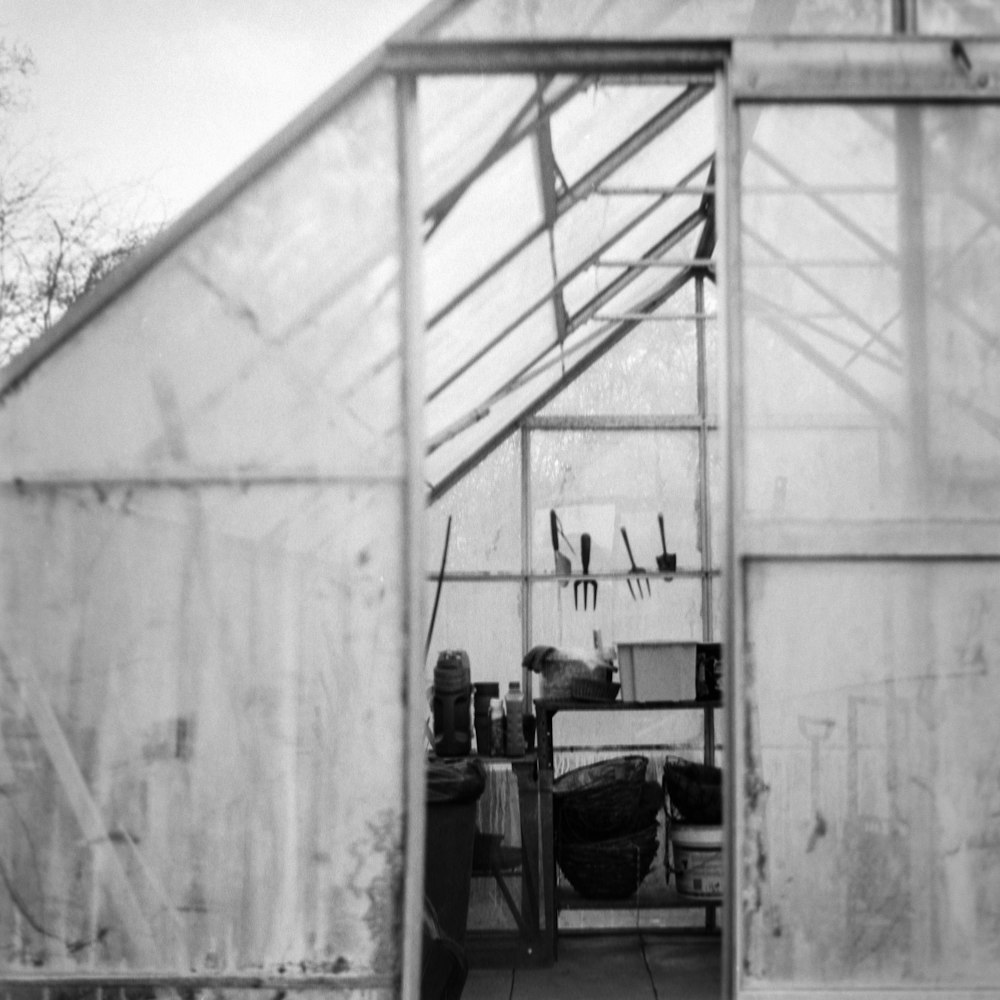 a black and white photo of a greenhouse