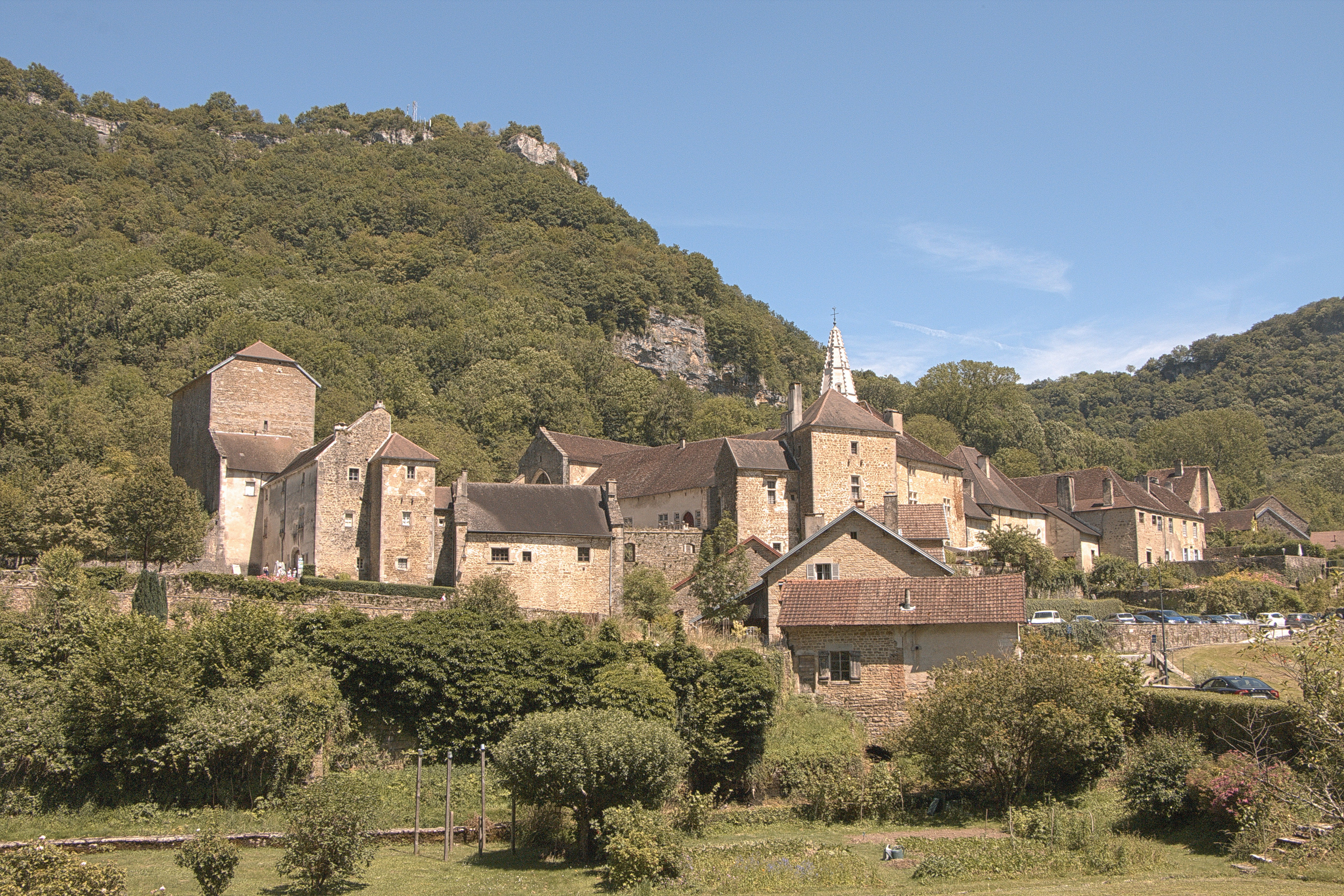 a large building sitting on top of a lush green hillside