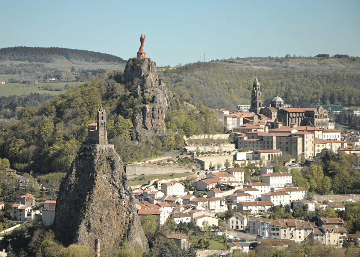 Le Puy-en-Velay, with the chapel of Saint-Michel d'Aiguilhe on its rock needle, the red statue of Notre-Dame de France and the cathedral tower