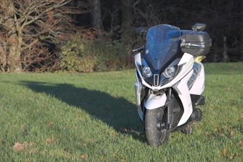 a white and blue motorcycle parked in the grass