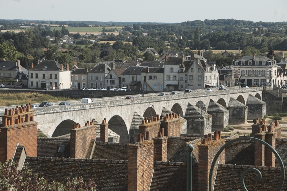 a view of a bridge over a river with buildings in the background