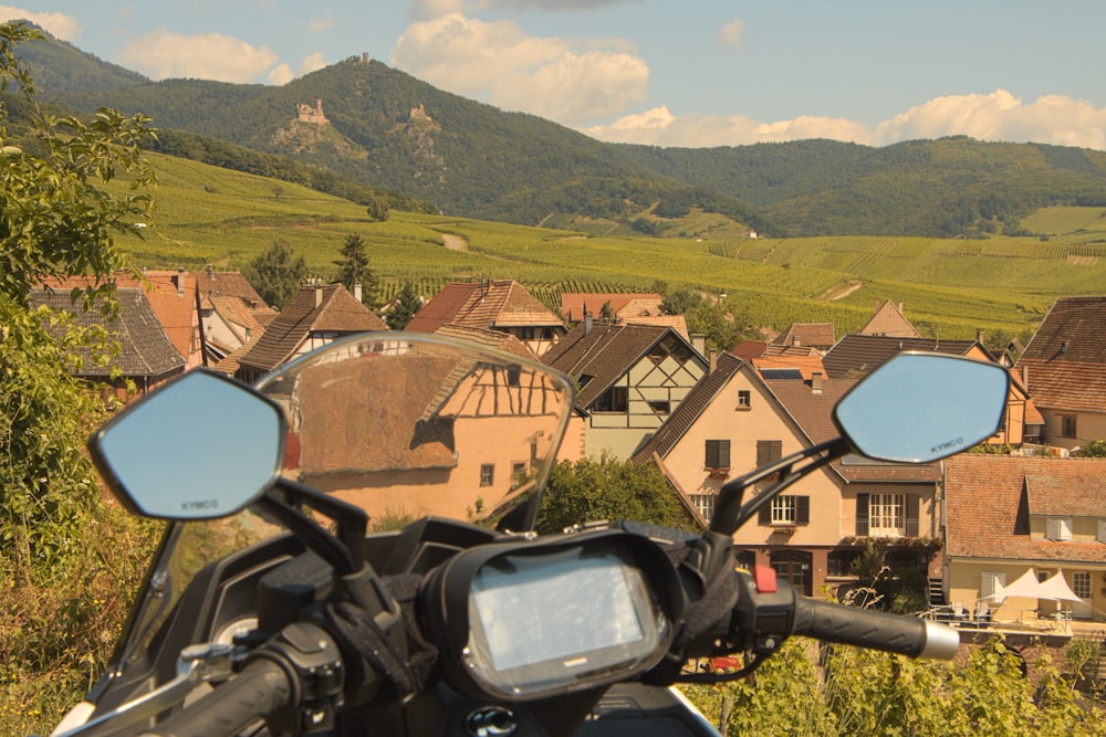 a motorcycle parked in front of a village
