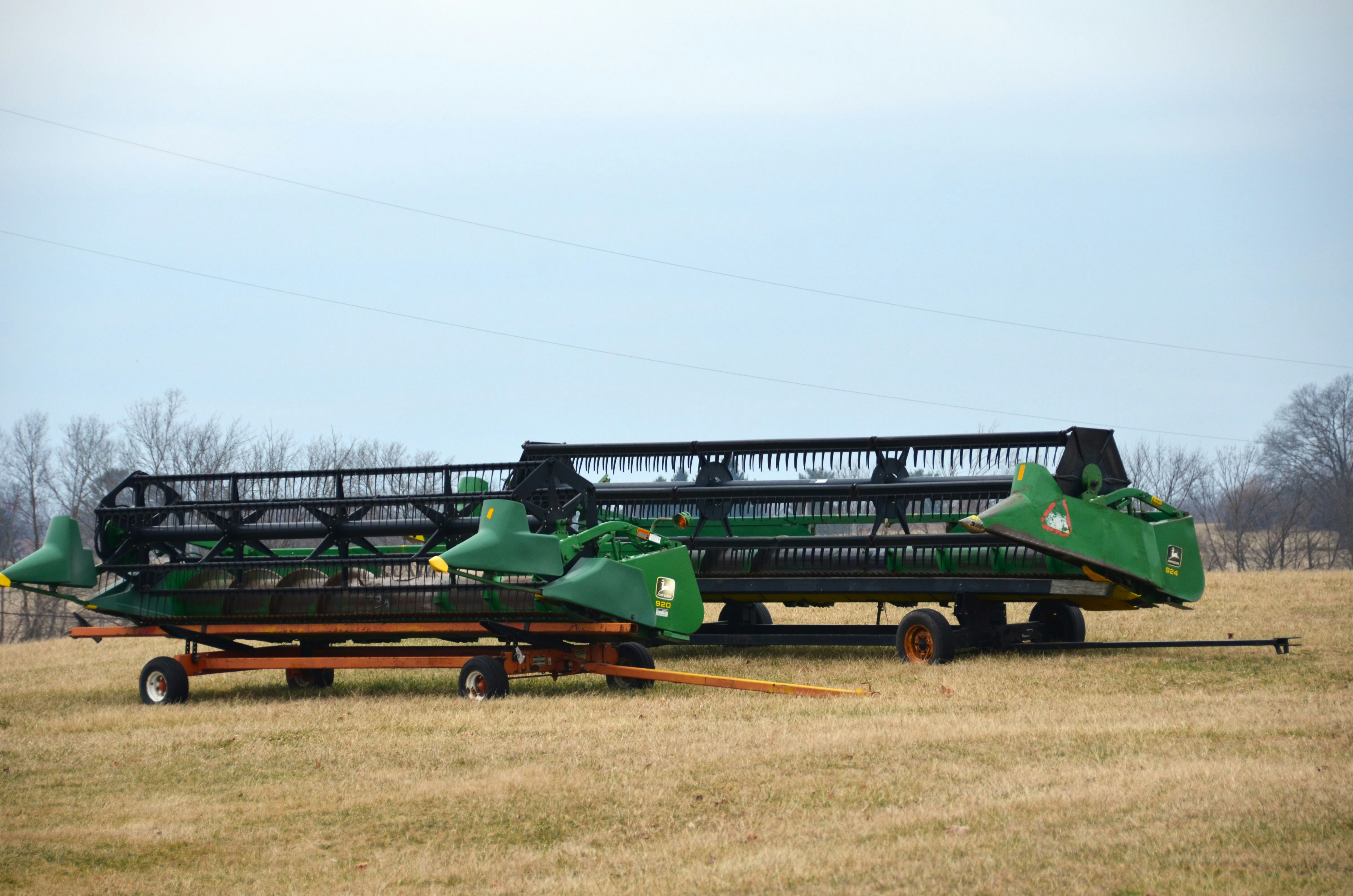 A tractor trailer with two green farm equipment on it photo – Free ...