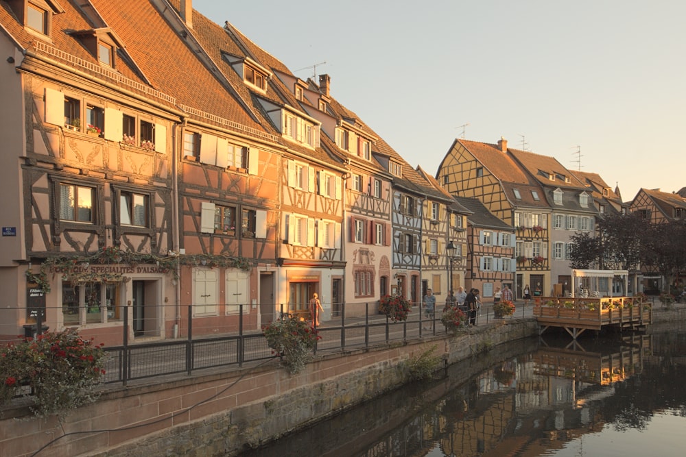 a row of buildings next to a body of water