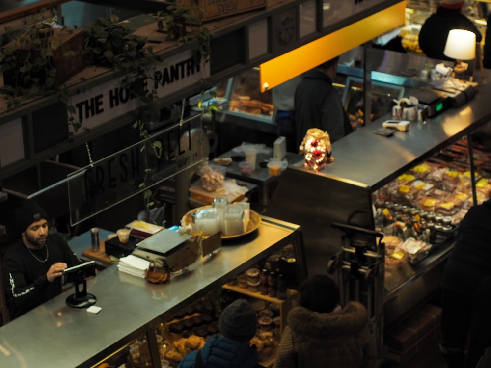 a group of people standing around a food court