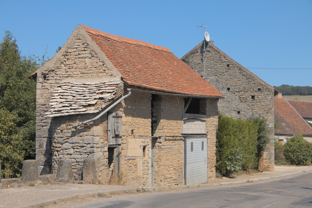 an old stone building with a red roof