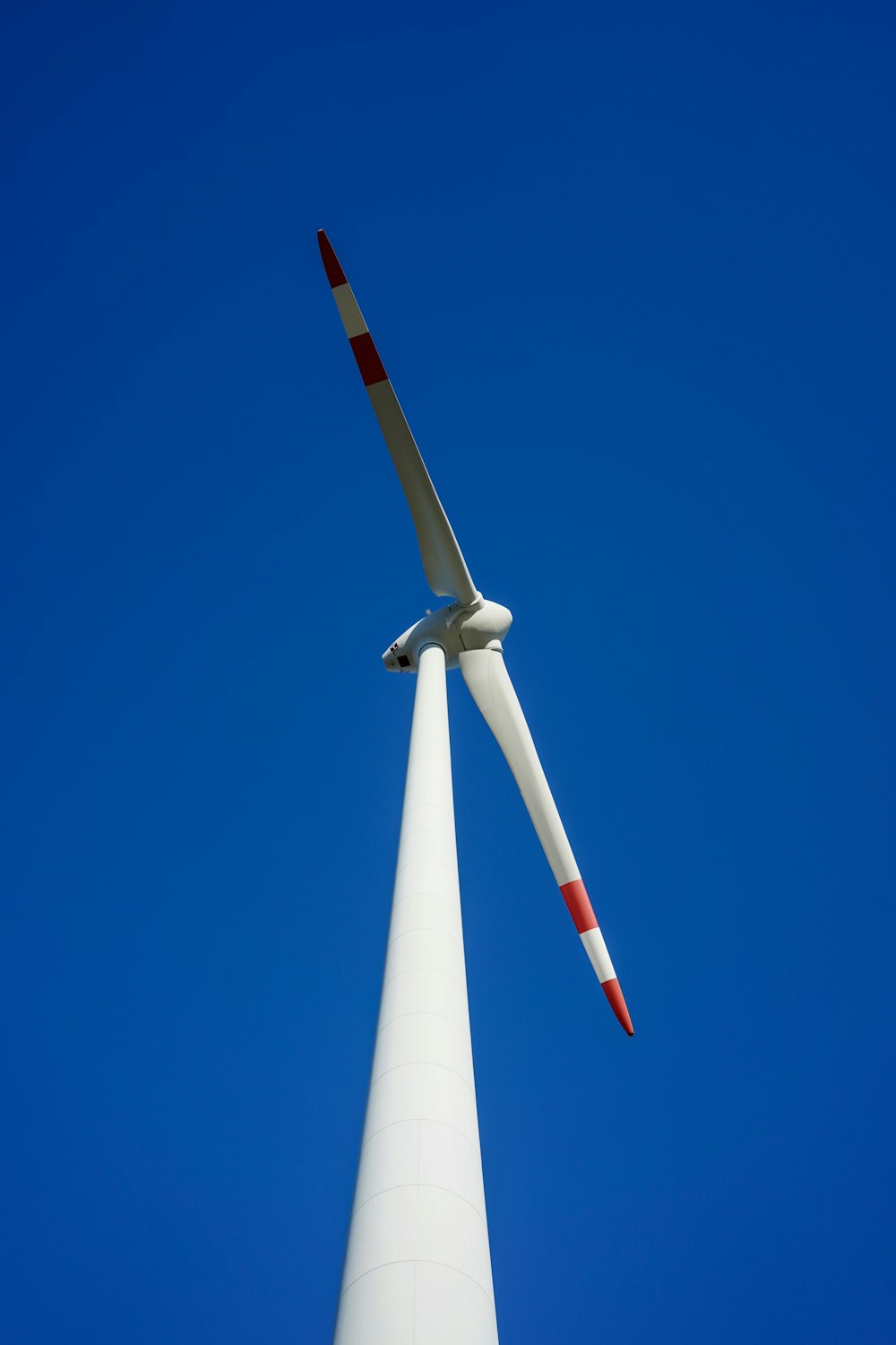 a large white wind turbine against a blue sky