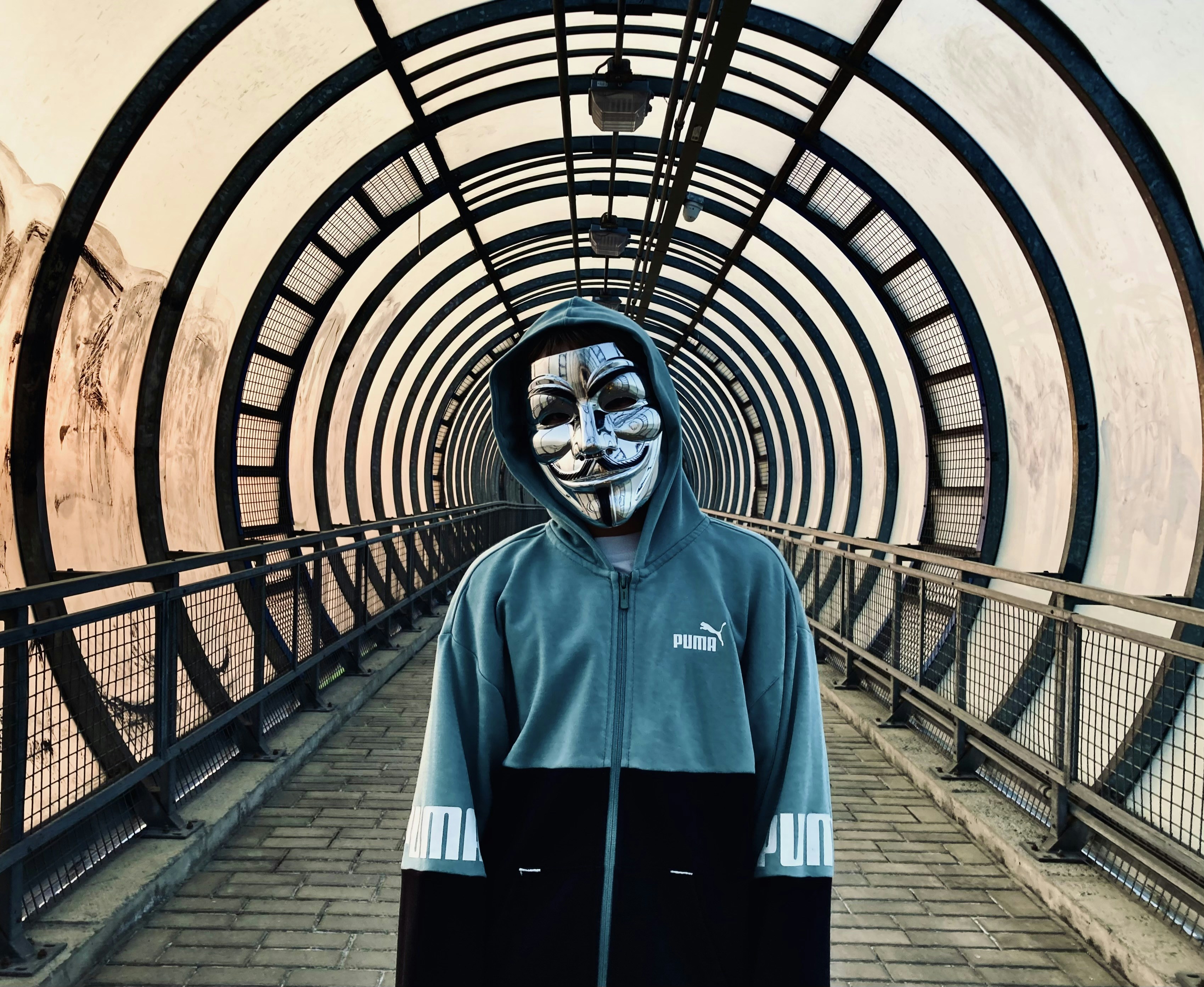 a person with a face painted in a tunnel