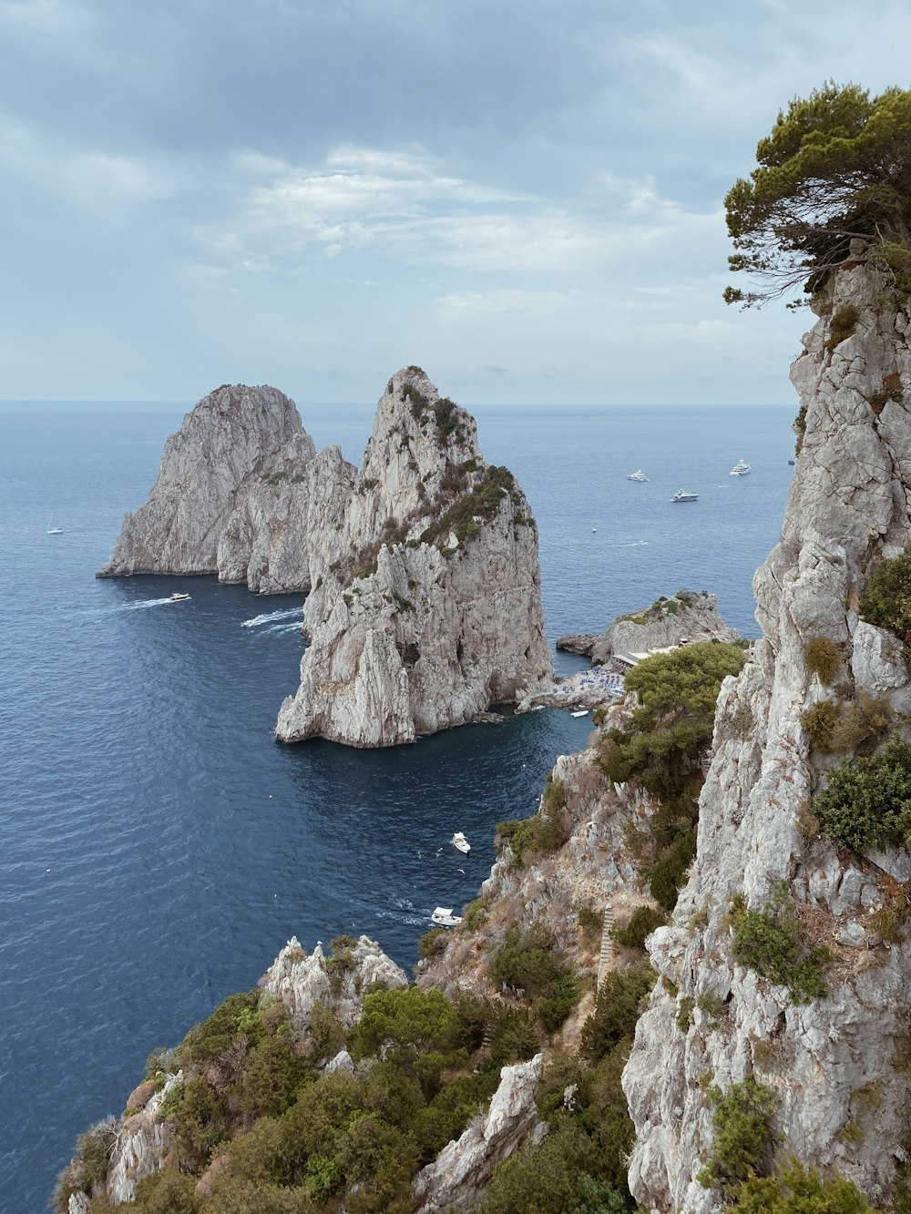 a couple of large rocks sitting on top of a cliff