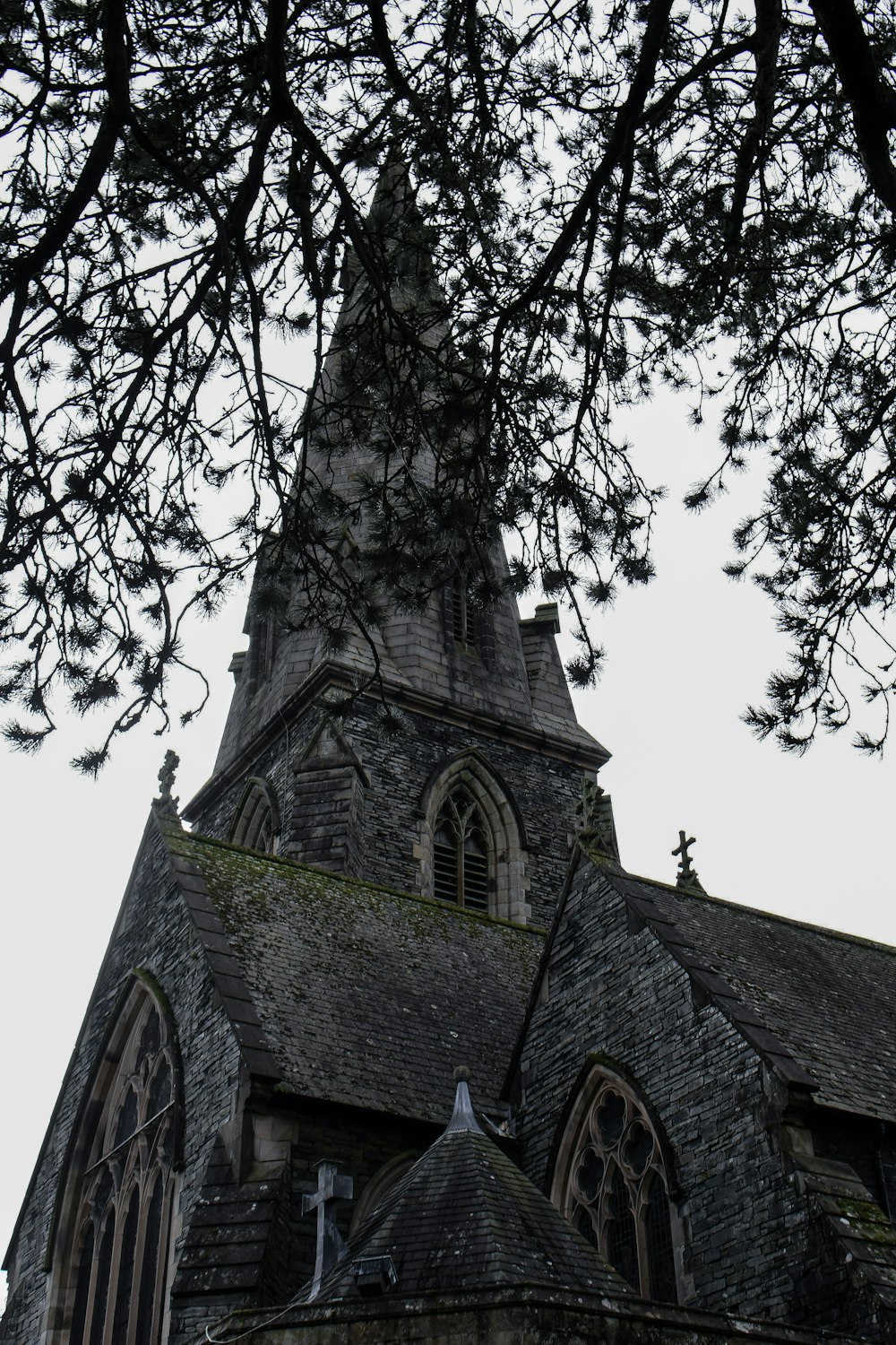 an old church with a steeple and a cross on it