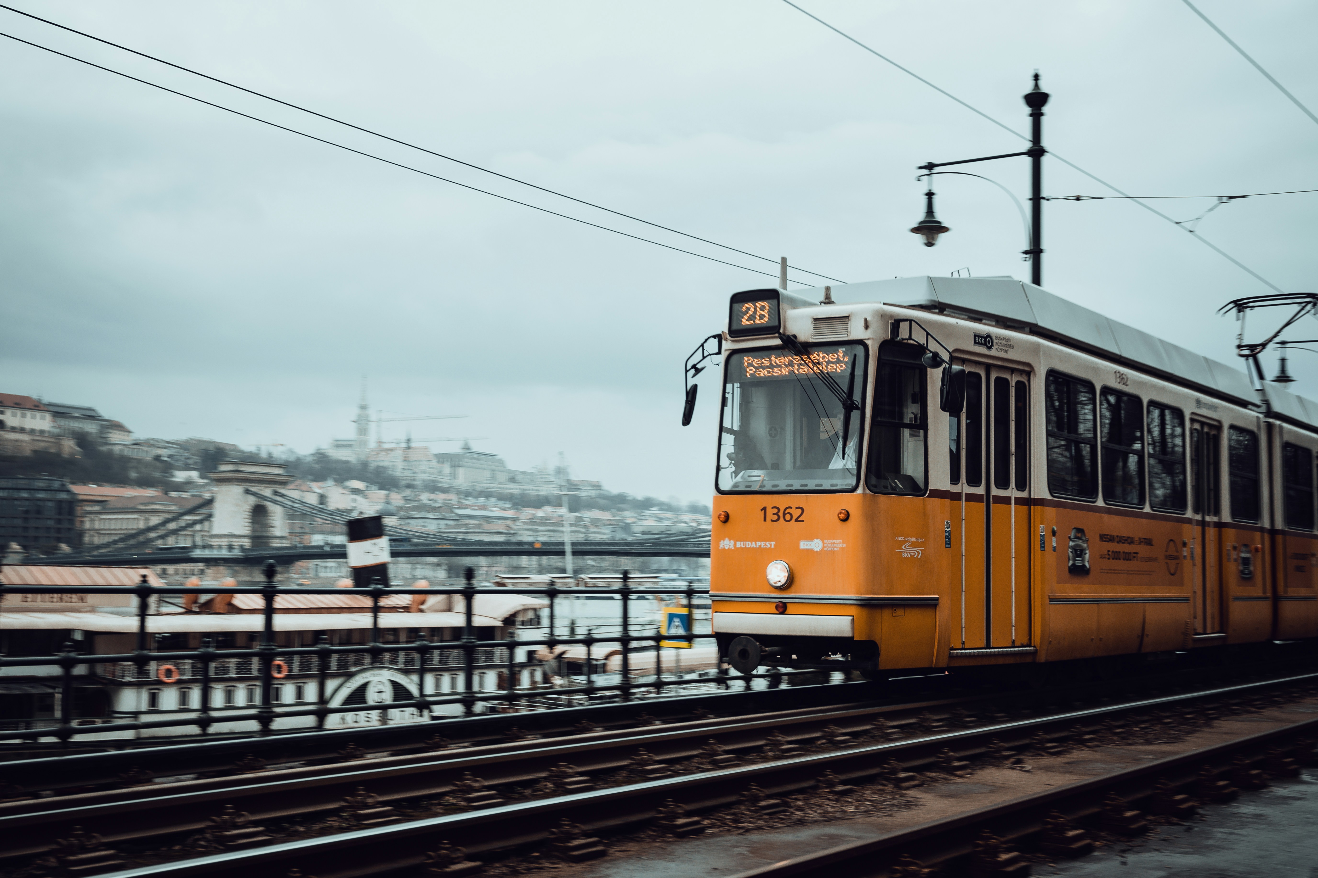 a yellow and white train traveling down train tracks