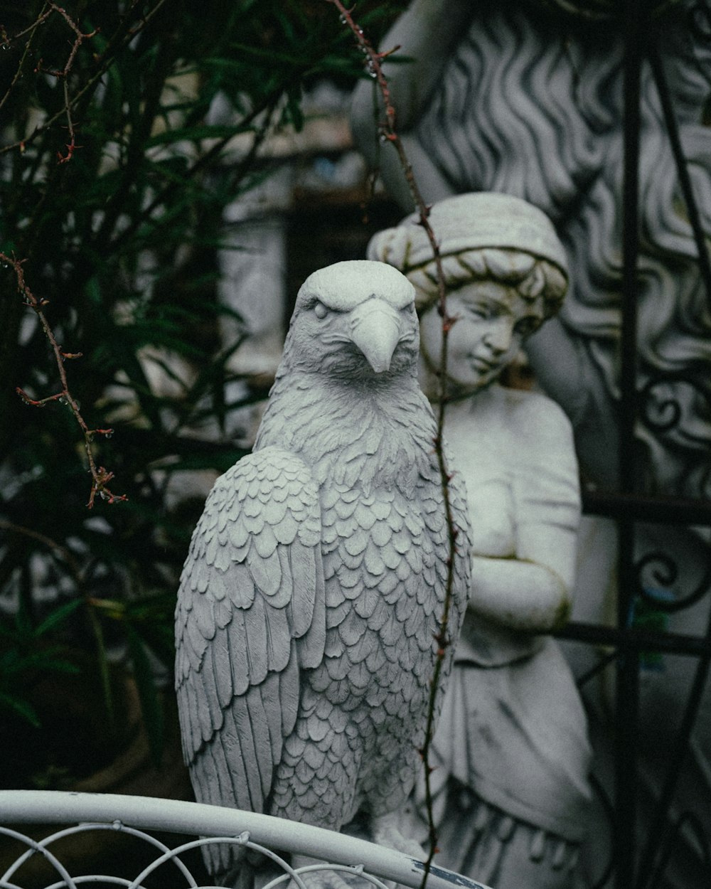 a statue of an owl and a statue of a woman