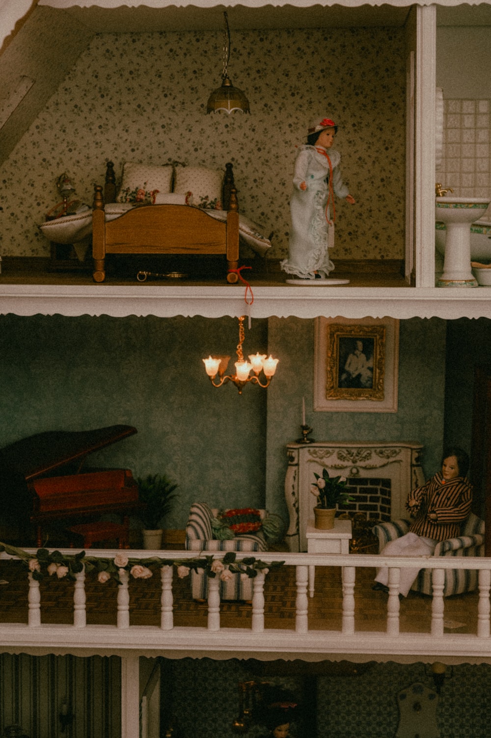 a doll house with a doll standing on top of it