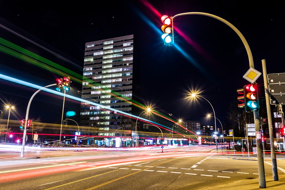 a city street filled with traffic lights at night