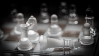 a close up of a chess board with white pieces