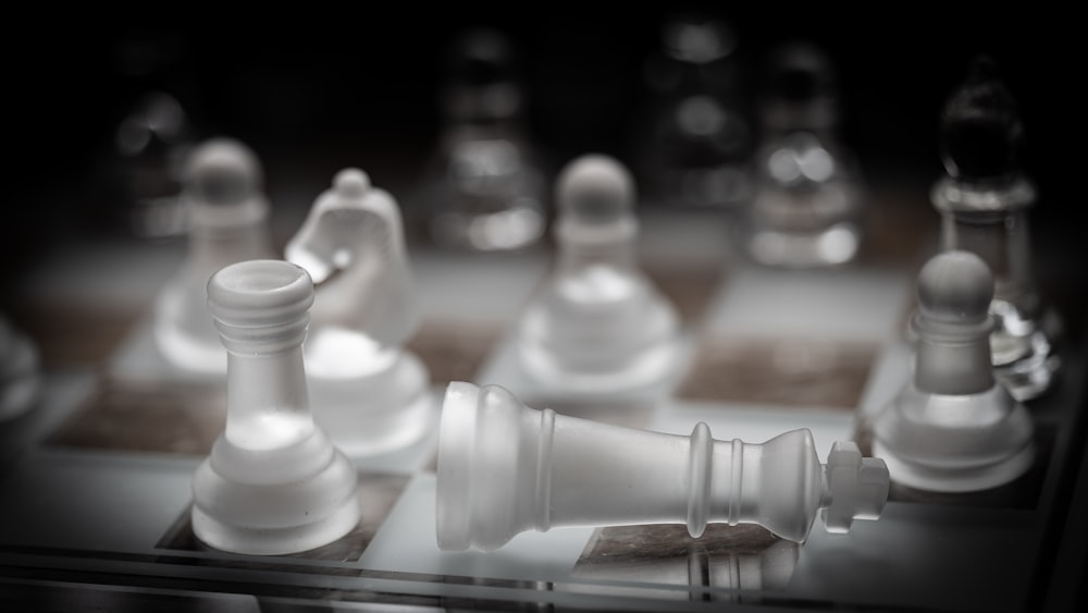 a close up of a chess board with white pieces