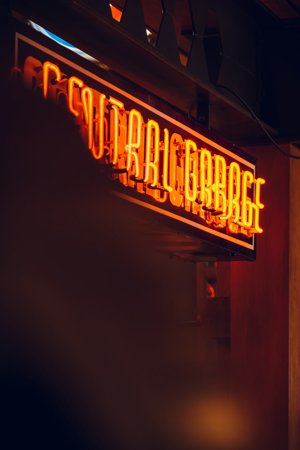 a neon sign that is hanging from the side of a building