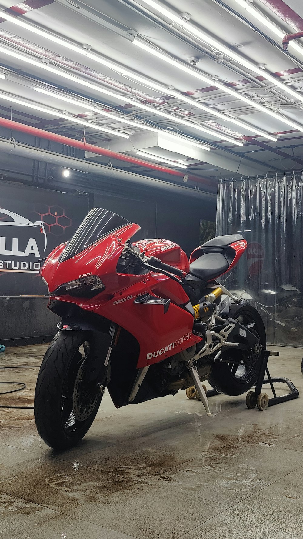 a red motorcycle parked inside of a garage