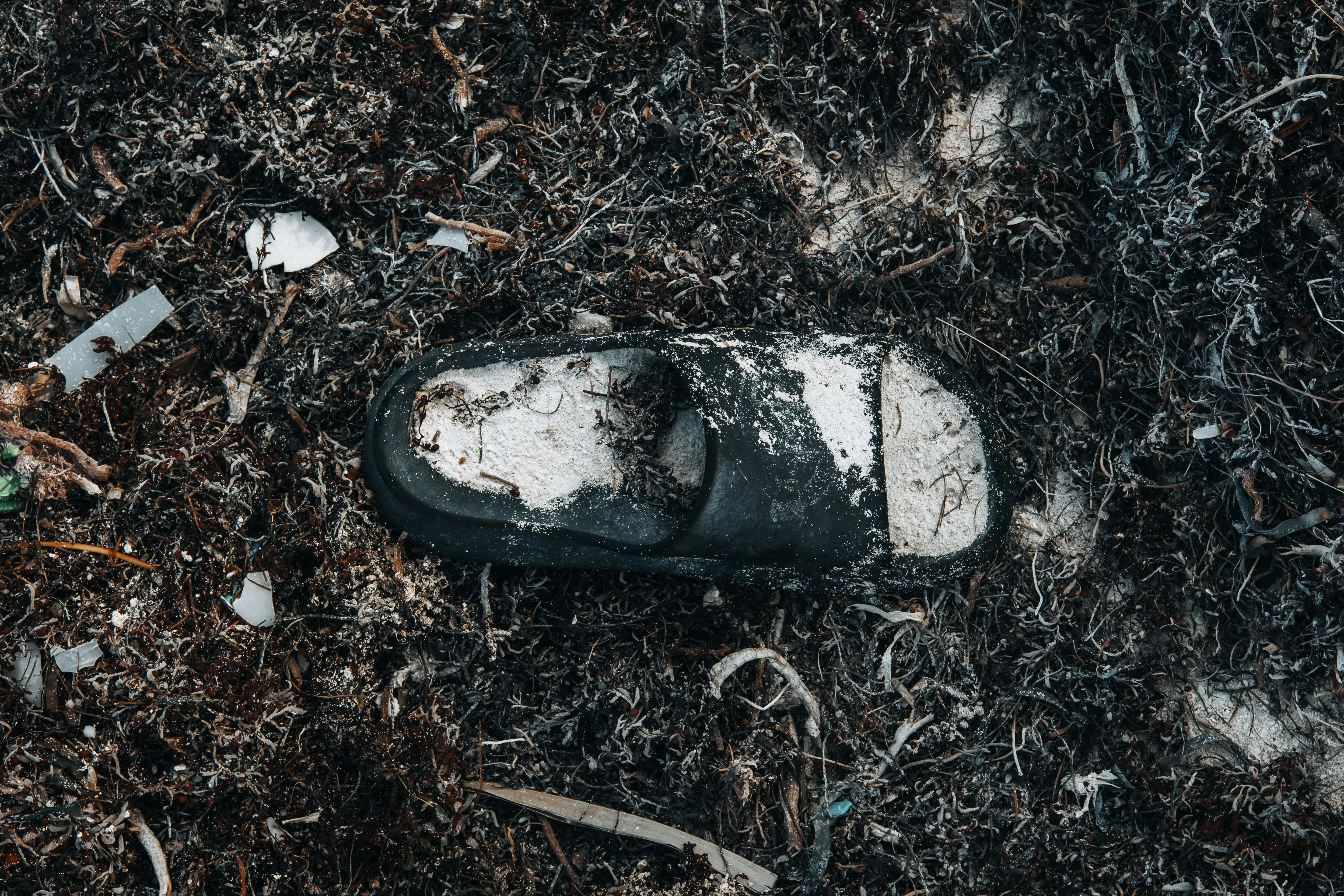 a dirty pair of shoes left on the ground