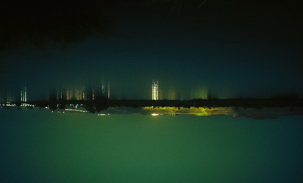 a view of a city at night from the water