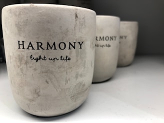 three white cups sitting on top of a table