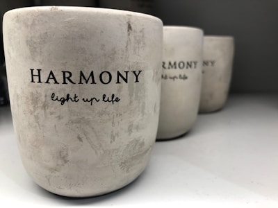 three white cups sitting on top of a table