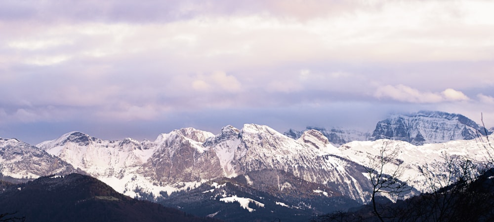 a mountain range with snow covered mountains in the background