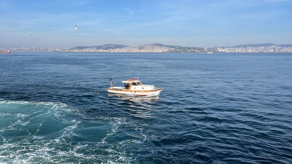 a small boat in the middle of the ocean