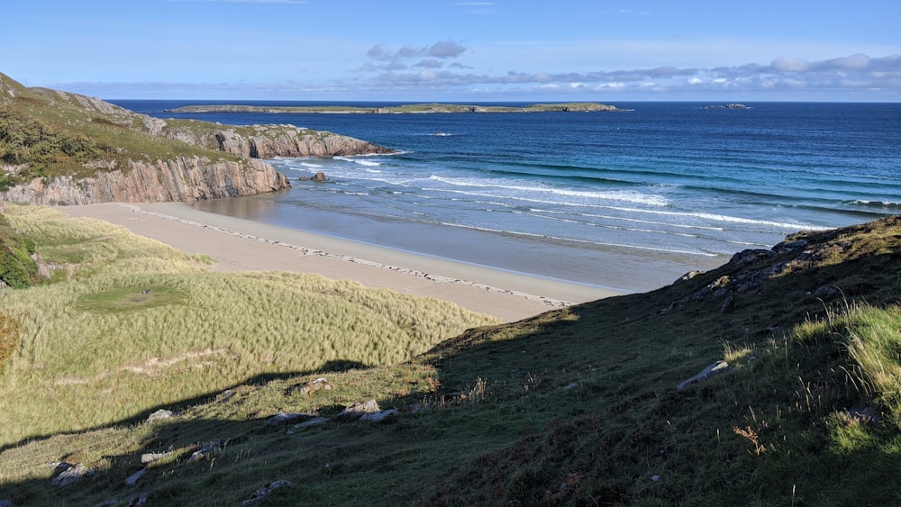 a view of a beach from the top of a hill