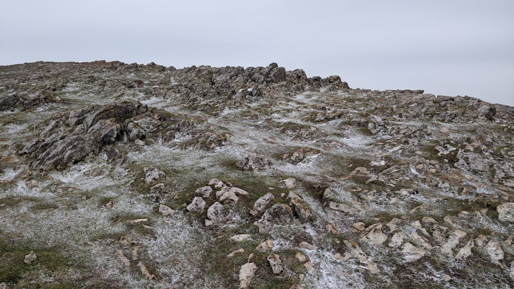 a rocky hill covered in grass and rocks