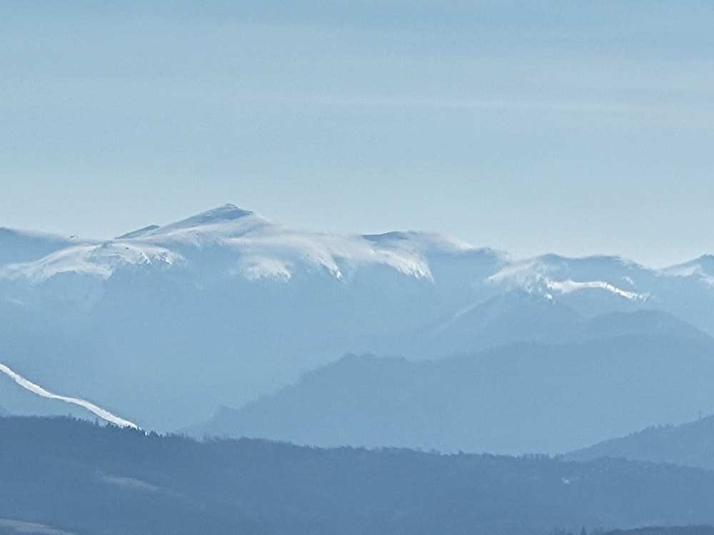 a mountain range covered in snow in the distance