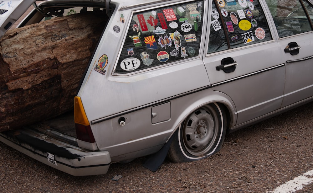 a car with a tree trunk on the back of it