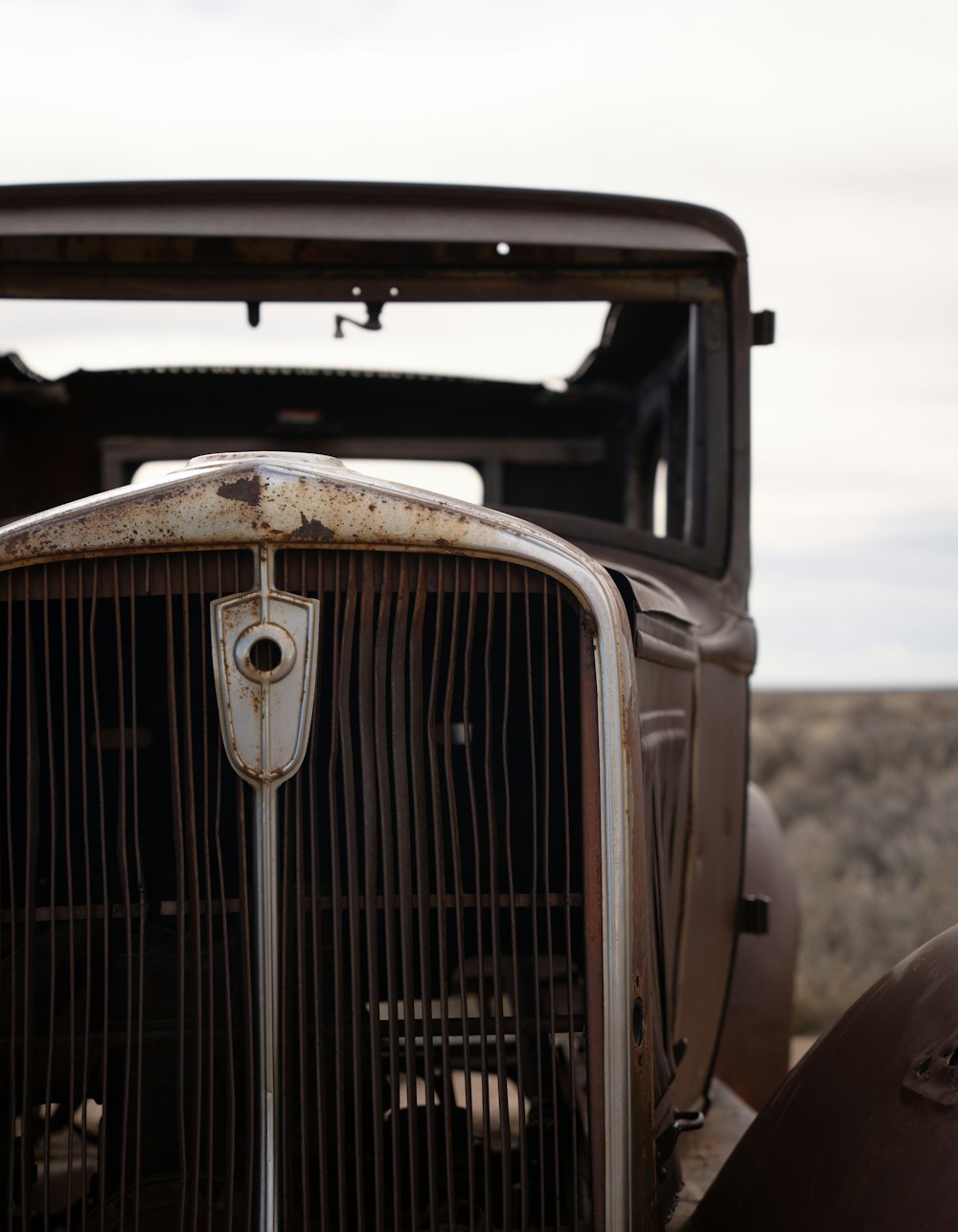 an old car with a grill on the front of it