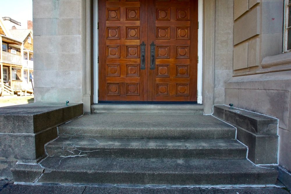 a large wooden door sitting on the side of a building