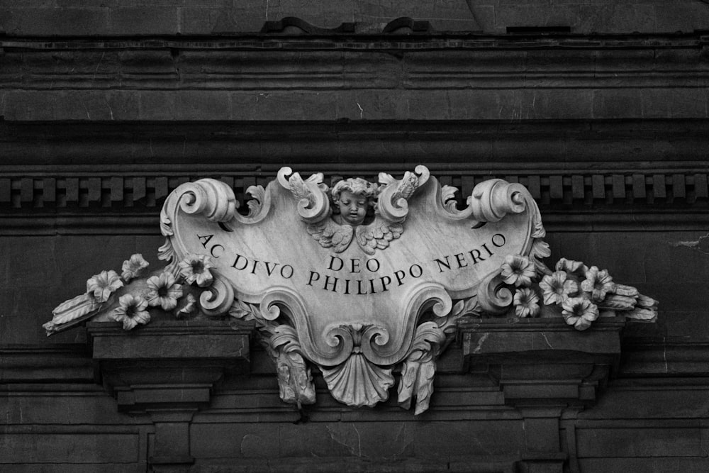 a black and white photo of a sign on a building