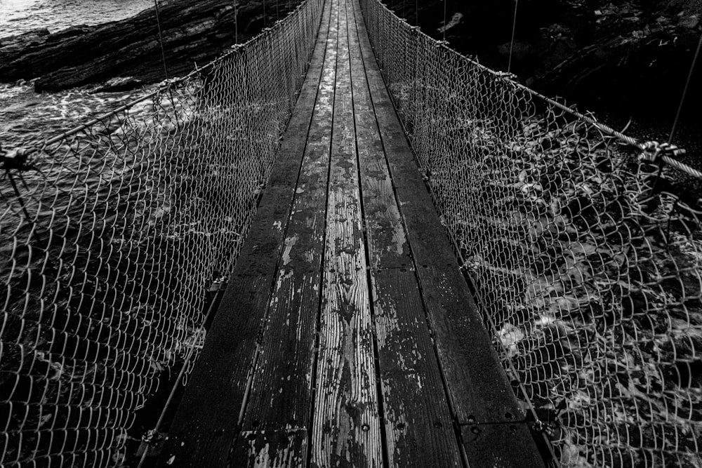 a black and white photo of a suspension bridge