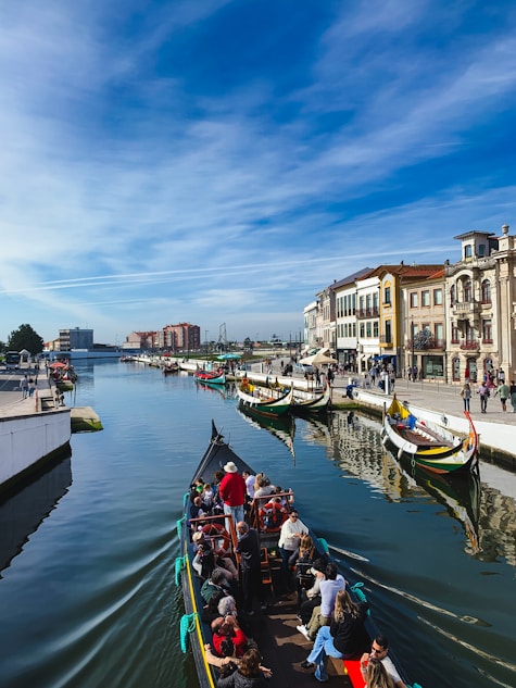 a group of people riding on top of a boat down a river