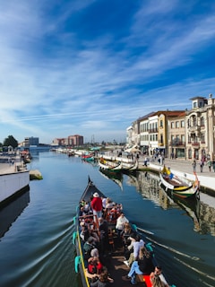 a group of people riding on top of a boat down a river