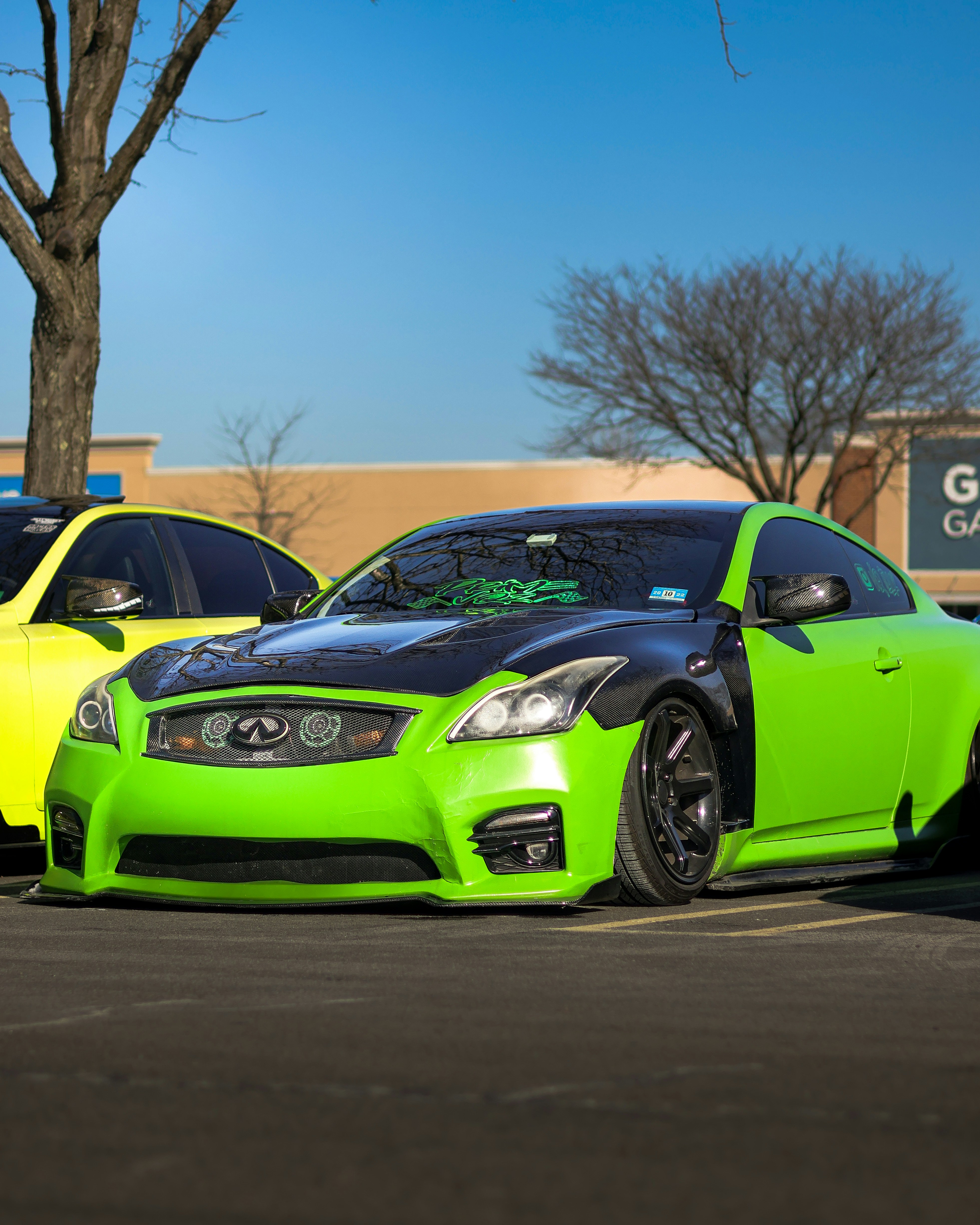 a couple of cars parked next to each other in a parking lot