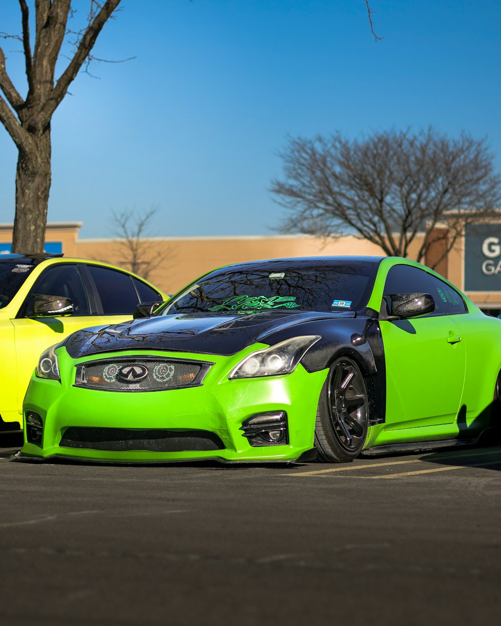 a couple of cars parked next to each other in a parking lot