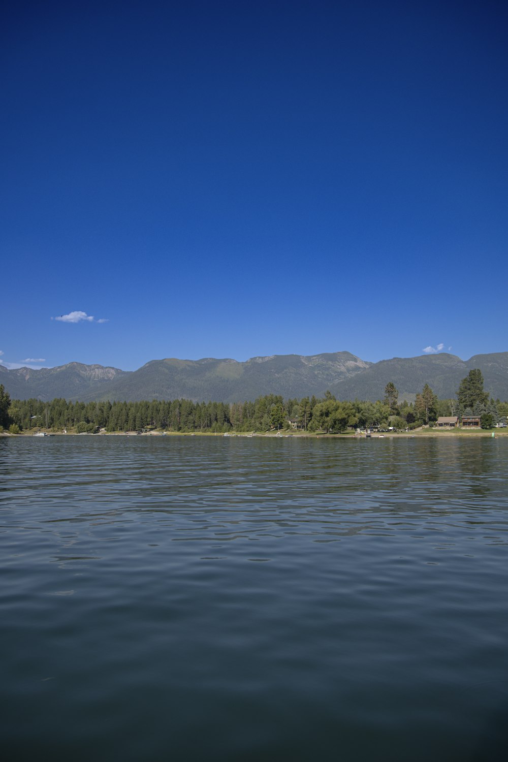 a body of water with mountains in the background