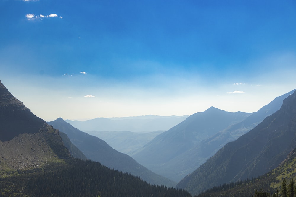 a view of a valley with mountains in the background