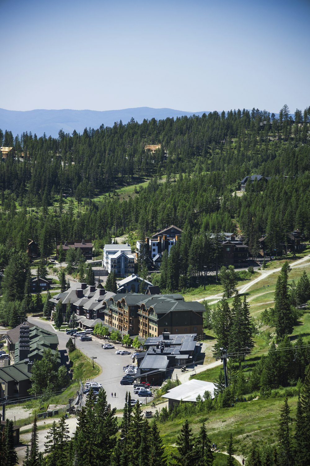 a scenic view of a town surrounded by trees