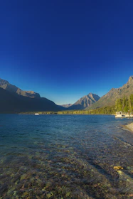 a body of water with mountains in the background