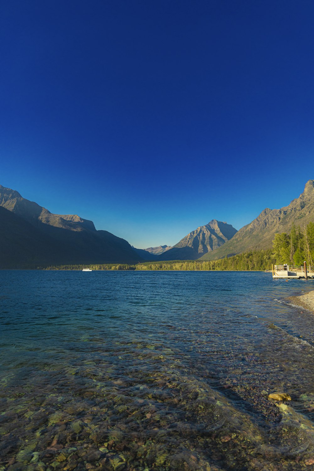 a body of water with mountains in the background