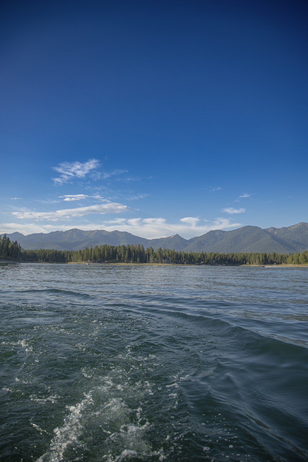 a body of water with mountains in the background