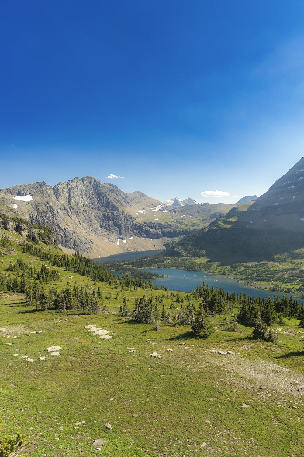 a view of a mountain range with a lake in the foreground