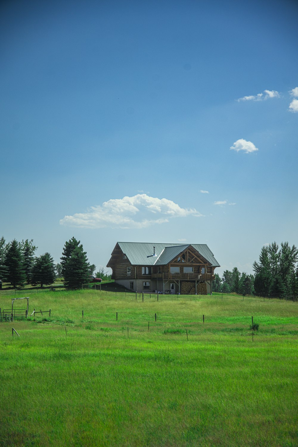 a house in the middle of a grassy field